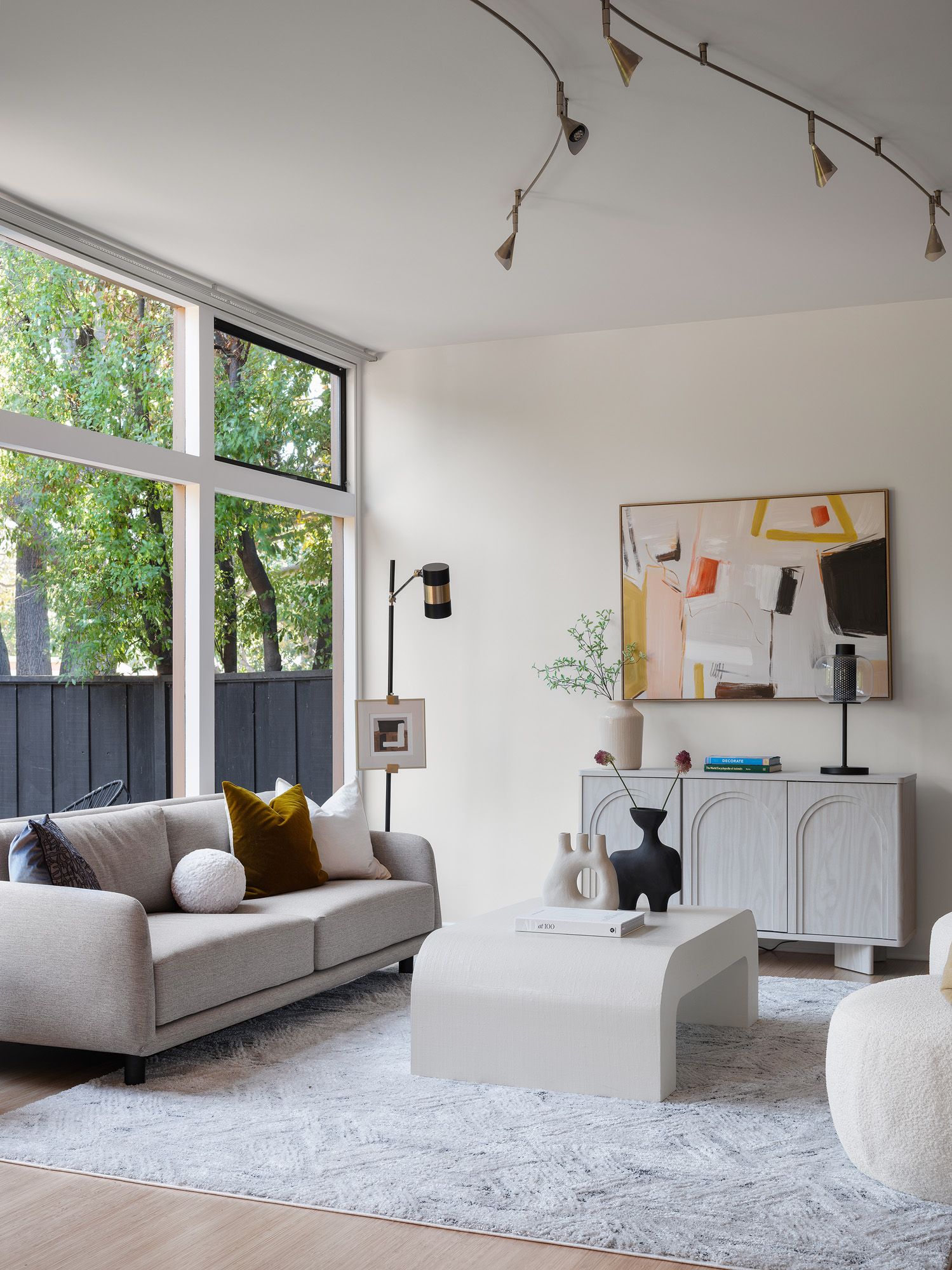 Light-filled beige living room with warm neutral walls illustrating summer paint color shifts