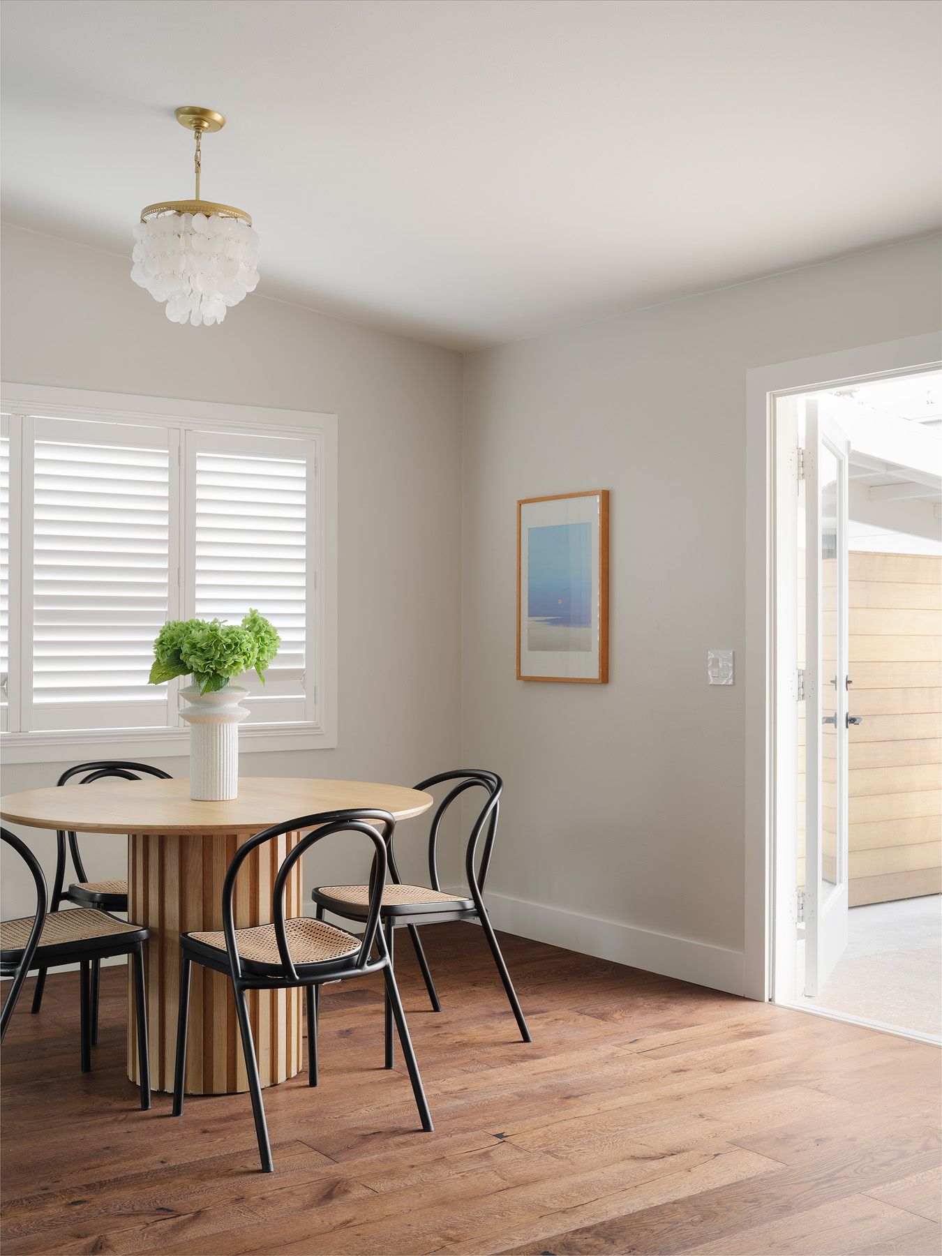 Bright breakfast nook with round oak table showing a dining area ready for first-week buyer tours